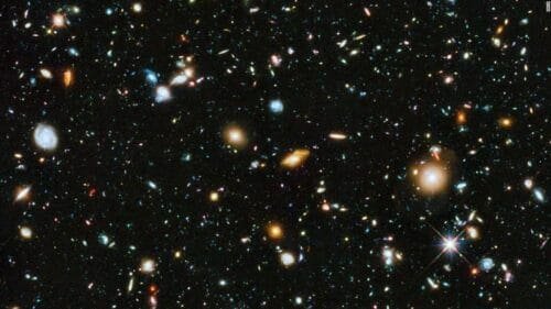 This is an image of space taken from a telescope and it shows a bunch of stars and galaxies that are way far off.
